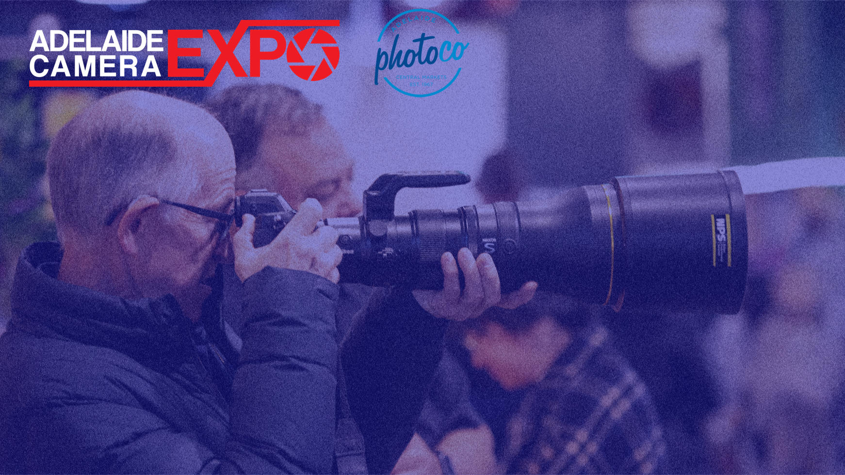 photographer shooting with a camera and telephoto lens